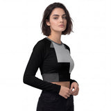 Front-right view of the 'Abstract Geometry' all-over print women’s crop top long sleeve by HOLO streetwear. Black dominates the design, covering the sleeves and part of the torso. A lighter gray blends with the black on the torso, creating a striking 'ladder' effect. The look is finished with a darker gray stripe in double waistband that begins at the center of the belly and extends to the middle of the back for a bold streetwear aesthetic.