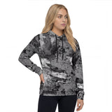 Front-right view of a all over print women’s hoodie by HOLO streetwear. Blight design features an impression of a decaying surface that time has taken its toll on. Very detailed and in grayscale.