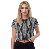 Front view of a women’s all-over printed crop t-shirt by HOLO streetwear. Marb Dark & ​​Grey Design is an eye-catching pattern balanced with greyscale. A rhombus shape stands out in the center of the chest with irregular mirrored shapes all around.
