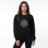 A woman modeling a black crewneck sweatshirt with a gray mandala-style graphic printed on the chest, set against a plain white studio background.
