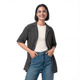 Front view of a black and gray women’s all-over printed button shirt by HOLO Streetwear, featuring the Zig Zag design. The pattern consists of parallel zigzag lines alternating between black and gray, almost creating a optical illusion effect at a certain distance. A bold streetwear piece that combines movement and contrast for a dynamic look.